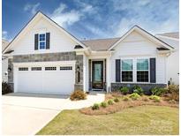 Charming single-story home with a two-car garage, stone accents, and a well-manicured front yard at 7337 Overjoyed Xing, Charlotte, NC 28215
