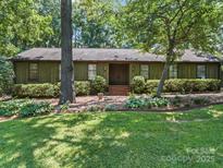 Charming one story home featuring beautiful landscaping and a welcoming entrance at 2104 Stoneyridge Dr, Charlotte, NC 28214