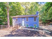 Charming blue two-story home with a fenced yard and mature trees, offering privacy and curb appeal at 2116 Bon Villa Way, Fort Mill, SC 29708