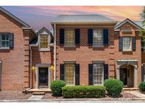 Charming brick townhouse with black shutters and landscaped front yard at 2825 Sharon View Rd, Charlotte, NC 28210