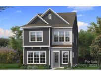 Charming two-story home boasts a symmetrical design, complemented by gray siding, and white trimmed windows at 3103 Middle St # 92, Charlotte, NC 28278