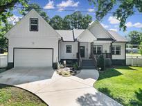 Charming white two-story home features a well-manicured lawn and an attached garage with a concrete driveway at 333 Anne Ave, Waxhaw, NC 28173