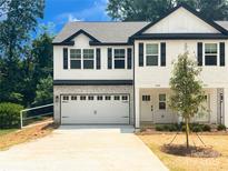 Charming new construction townhouse with a two-car garage and a manicured front yard at 3926 Litchfield Rd, Charlotte, NC 28211