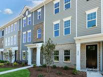 Attractive townhouse with gray siding, white trim, brick accents and well-kept lawn at 11021 Warfield Ave # 03, Huntersville, NC 28078