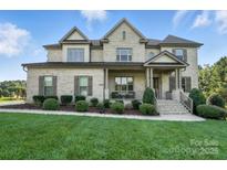 A charming two-story brick home with a lush green lawn and well-maintained landscaping at 200 Squash Harvest Ct, Matthews, NC 28104