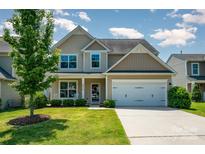 Charming two-story home with landscaped yard, mature trees, and attached two-car garage at 3816 Ernie Dr, Charlotte, NC 28269
