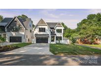 Striking two-story home with modern design, neat lawn, dark garage door, and paved driveway at 4349 Castleton Rd, Charlotte, NC 28211