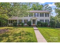 Charming two-story home featuring manicured landscaping, a walkway, and a welcoming entrance at 9833 White Cascade Dr, Charlotte, NC 28269