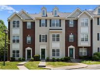 Charming townhome featuring a well-maintained lawn, brick accents, and a welcoming entryway at 10094 Treeside Ln, Matthews, NC 28105