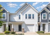Charming two-story townhouse with white siding, garage, well-manicured lawn, and a covered porch at 172 Briana Marie Way, Indian Trail, NC 28079
