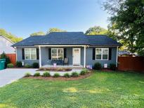 Charming one story home featuring a well-manicured lawn and beautiful landscaping at 1723 Lowder St, Albemarle, NC 28001