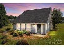 Charming single-story home with large windows, well-kept lawn, and mature landscaping at 2268 Bay Ct, Newton, NC 28658