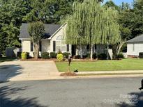 Charming single-story home with mature landscaping, a well-manicured lawn, and welcoming front porch at 2289 Kestrel Dr, Rock Hill, SC 29732