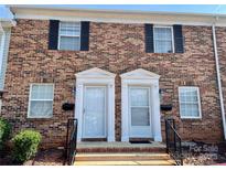 Charming brick townhome featuring black shutters and a well-maintained front entrance with white doors at 250 Nixon Rd # 41, Belmont, NC 28012