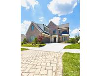 Beautiful brick two-story home with an attached garage and a spacious driveway under a bright sky at 3011 Ella Katherine Way, Charlotte, NC 28210