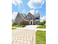 Beautiful brick home featuring a spacious driveway, manicured lawn and a two-car garage at 3011 Ella Katherine Way, Charlotte, NC 28210