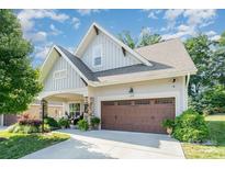 Charming home features a two-car garage and a beautifully landscaped front yard at 3899 Zemosa Nw Ln, Concord, NC 28027