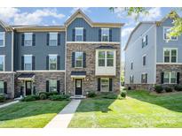 Charming townhome with stone and siding facade, complemented by a well-maintained lawn at 4436 Carteret St, Charlotte, NC 28205