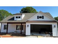 Charming two-story white home with a covered front porch, gray roof, and an attached garage under construction at 4940 Southview Dr, Hickory, NC 28602