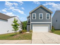 Charming two-story home with blue siding and a well-maintained front yard at 5010 Arbordale Way, Mount Holly, NC 28120