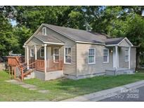 Charming single-story home featuring a covered front porch and mature trees at 603 Paradise St, Monroe, NC 28112