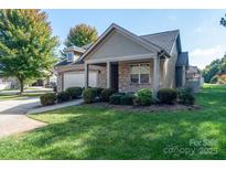 Charming exterior with stone and siding, complemented by a well-manicured lawn and inviting curb appeal at 860 Wynnshire Dr, Hickory, NC 28601