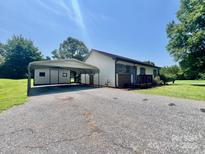 Charming home featuring a carport, shed, and a well-maintained yard at 1678 Nelson Dr, Newton, NC 28658