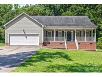 Charming single-story home with a welcoming front porch and attached garage at 1921 Williford Woods Ln, Rock Hill, SC 29730