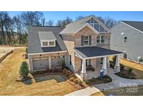 Charming two-story brick home with a covered front porch and a two-car garage at 2005 Waxhaw Crossing Dr # 241, Waxhaw, NC 28173