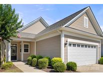 Charming single-story home with a well-manicured lawn and attached two car garage at 20241 Dovekie Ln, Indian Land, SC 29707
