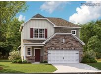Charming two-story home featuring stone accents, a two-car garage, and a welcoming front entrance at 233 Runner Stone Ln, Fort Mill, SC 29715