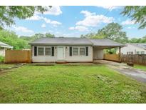 Charming single-story home featuring a covered carport and a well-maintained front lawn at 2509 1St St, Statesville, NC 28677