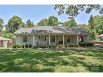 Charming single-story home with a welcoming front porch and well-maintained landscaping at 5301 Addison Dr, Charlotte, NC 28211