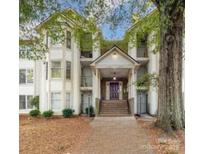 Inviting condo exterior features a covered entrance, stairs, and well-maintained landscaping at 6260 Rosecroft Dr, Charlotte, NC 28215