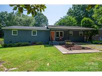 Charming single-story home with a well-maintained lawn, inviting walkway, and quaint front porch at 108 Graham St, Stanley, NC 28164