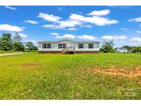 Charming single-story home featuring a welcoming front porch and well-maintained lawn at 1133 Lynn Ln, Catawba, NC 28609