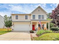 Charming two-story home with a manicured lawn, American flag, and a red front door at 1288 Century Dr, Clover, SC 29710