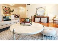 Bright living room featuring stylish furnishings, hardwood floors, and unique decor at 1323 Queens Rd # 327, Charlotte, NC 28207