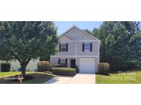 Charming two-story home featuring a single-car garage and manicured landscaping at 165 Brantley Place Dr, Mooresville, NC 28117