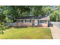 Charming brick home with a well-maintained front yard and mature trees at 1655 Woodhaven Rd, Rock Hill, SC 29732