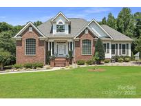 Charming brick home with manicured lawn and lovely landscaping at 1842 Caroline Way, Fort Mill, SC 29715