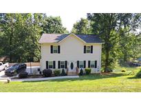 Charming two-story home with a well-manicured lawn and a lake view in the backyard at 729 Victoria Ln, Hickory, NC 28601