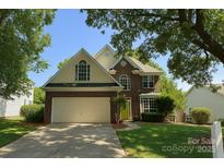 Charming two-story brick home with a well-manicured lawn and a two-car garage at 9029 Torrence Crossing Dr, Huntersville, NC 28078