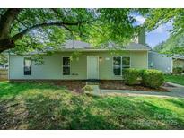 Charming single-story home with a well-maintained lawn and lush green surroundings at 9122 Nathaniel Russell Ln, Charlotte, NC 28227