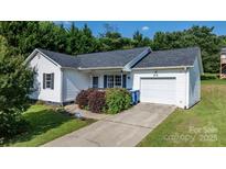 Charming single-Gathering home with white siding, black shutters, and a well-manicured lawn and a driveway at 1265 39Th Street Cir, Hickory, NC 28602