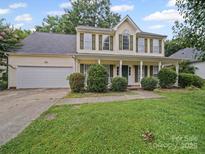 Charming two-story home featuring a welcoming front porch and a well-manicured lawn at 14520 Cardamon Ct, Charlotte, NC 28273