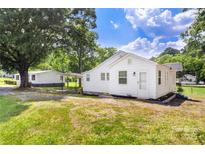 Charming white home with well-maintained lawn, detached garage, and carport on a sunny day at 2488 Catawba Church Rd, Rock Hill, SC 29730