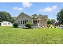 Charming single story home with a manicured lawn and inviting front porch at 29636 Lakeside Dr, Albemarle, NC 28001
