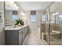 A spacious bathroom featuring a glass shower, double vanity, and modern fixtures at 3134 Beacon Heights Rd, Indian Land, SC 29707