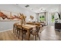 Open-concept dining area with modern decor and seamless flow to living space, perfect for entertaining and Gathering gatherings at 3136 Beacon Heights Rd, Indian Land, SC 29707